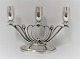 Lundin Antique 
presents: 
Evald 
Nielsen. 
3-armed silver 
candlestick. 
Height 17.5 cm. 
Length 25 cm. 
Produced 1949.
