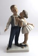 Lundin Antique 
presents: 
Lyngby. 
Porcelain 
figure. Girl 
and boy. Model 
93. Height 21 
cm. (1 quality)