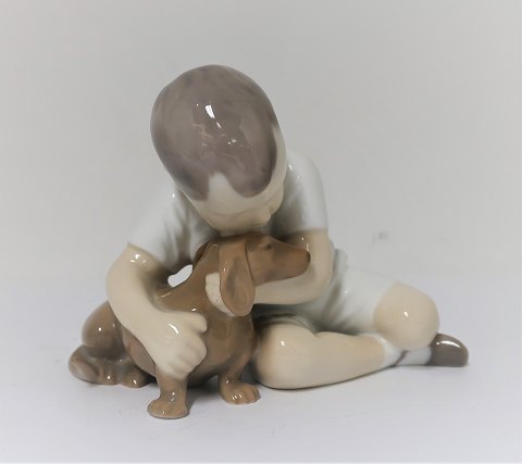 Bing & Grondahl. Porcelain figure. Boy with dog. Model 1951. Height 9 cm. (1 
quality)