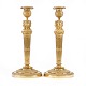 A pair of fire gilt bronze candlesticks. France circa 1810. H: 31cm