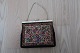 Vintage /retro:
Beautiful old handbag
Mit embroidery (but as far as we judge, not made by hand)
Beautiful closing item 
About 1950
