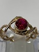 Antik Huset 
presents: 
14 carat 
gold ring with 
red faceted 
stone and 
diamonds. 
Stamped 585.
Ring size 52.