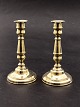 A pair of brass 
candlesticks on 
a round base