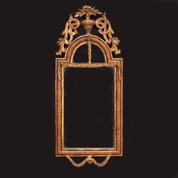 A partly gilt and walnut veneered Louis XVI mirror. Altona, Northgermany, circa 
1780. Size: 86x36cm