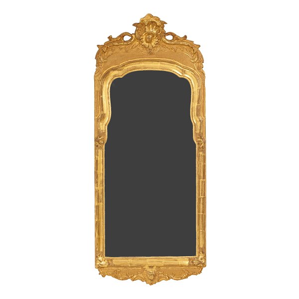 A gilt wood cut Rococo mirror. Denmark circa 1760. Measures: 120x51cm