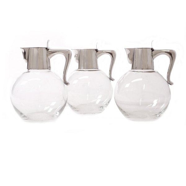 Set of three wine jugs with sterlingsilver mountings by Eigil Jensen, A. 
Michelsen, Copenhagen. H: 16cm